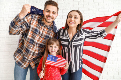 family holding US flag