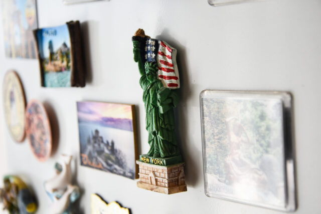 New york city magnet. Many magnets on the refrigerator from the countries of the world A new fridge magnet from the last vacation (travel concept)