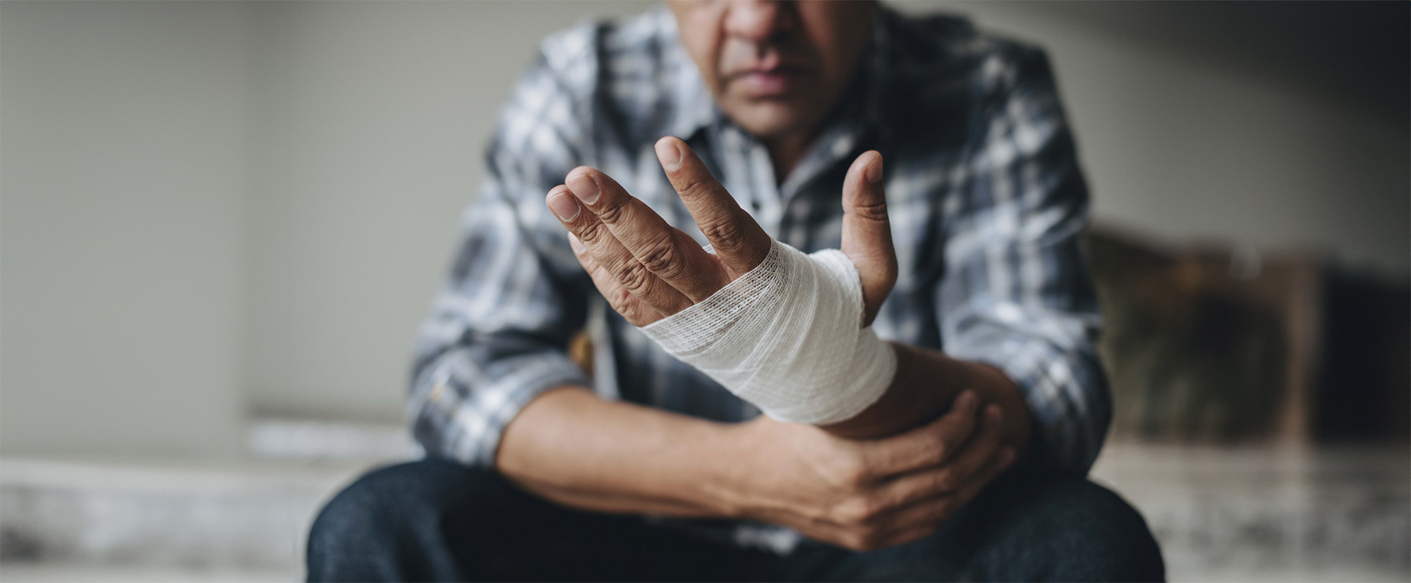 man with a gauze bandage wrapped around his hand