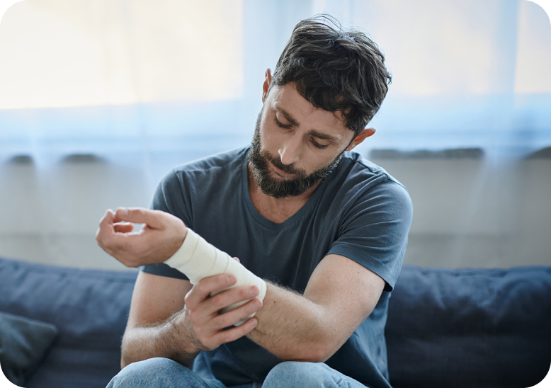 man holding his bandaged wrist